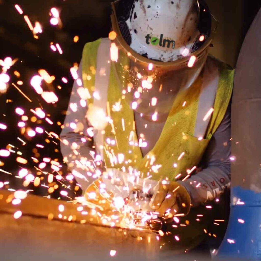 Sparks are flying while on the job as an employee uses a saw